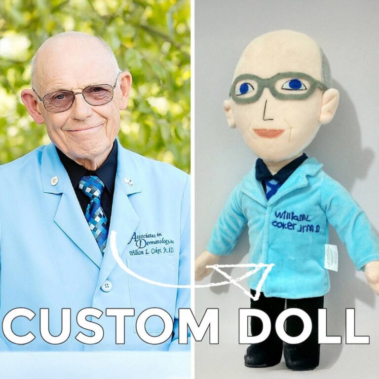 Elderly doctor beside his custom plush doll wearing a matching blue coat and glasses