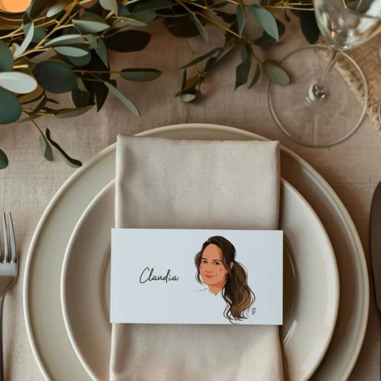 Place card with an illustrated portrait of Claudia on a folded beige napkin and plate