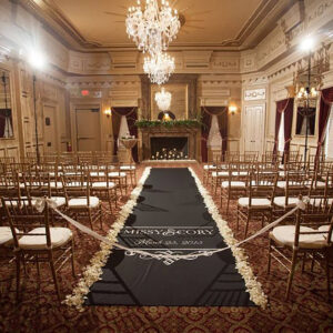 custom name printed black aisle runner with white petal edges at a wedding ceremony