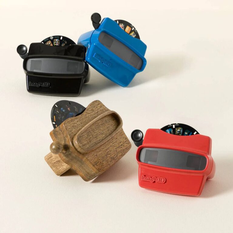 Four reel viewers - black, blue, walnut wood, and red - each loaded with a photo reel
