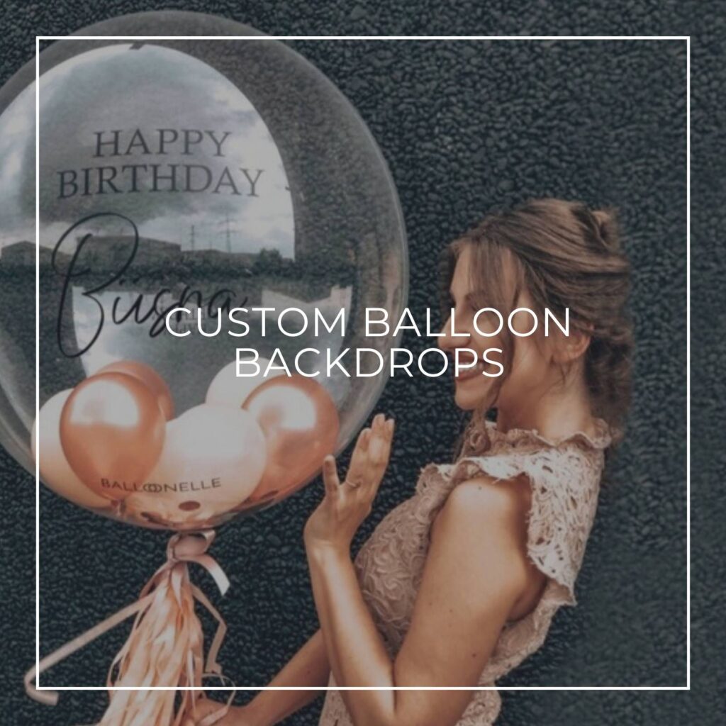 woman standing next to a custom text and name transparent balloon filled with mini balloons