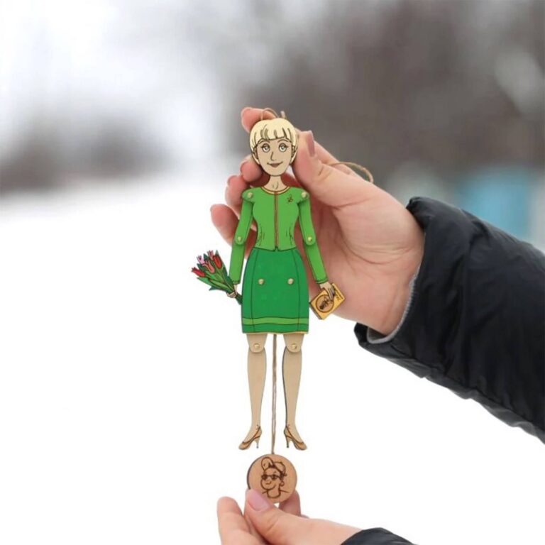 Custom wooden portrait ornament of a woman in a green dress holding tulips, showing the pull-string mechanism and engraved face disc