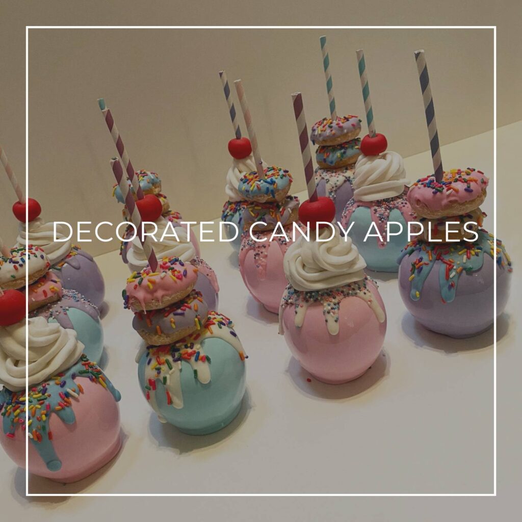 decorated candle apples with donuts, cream, and straws