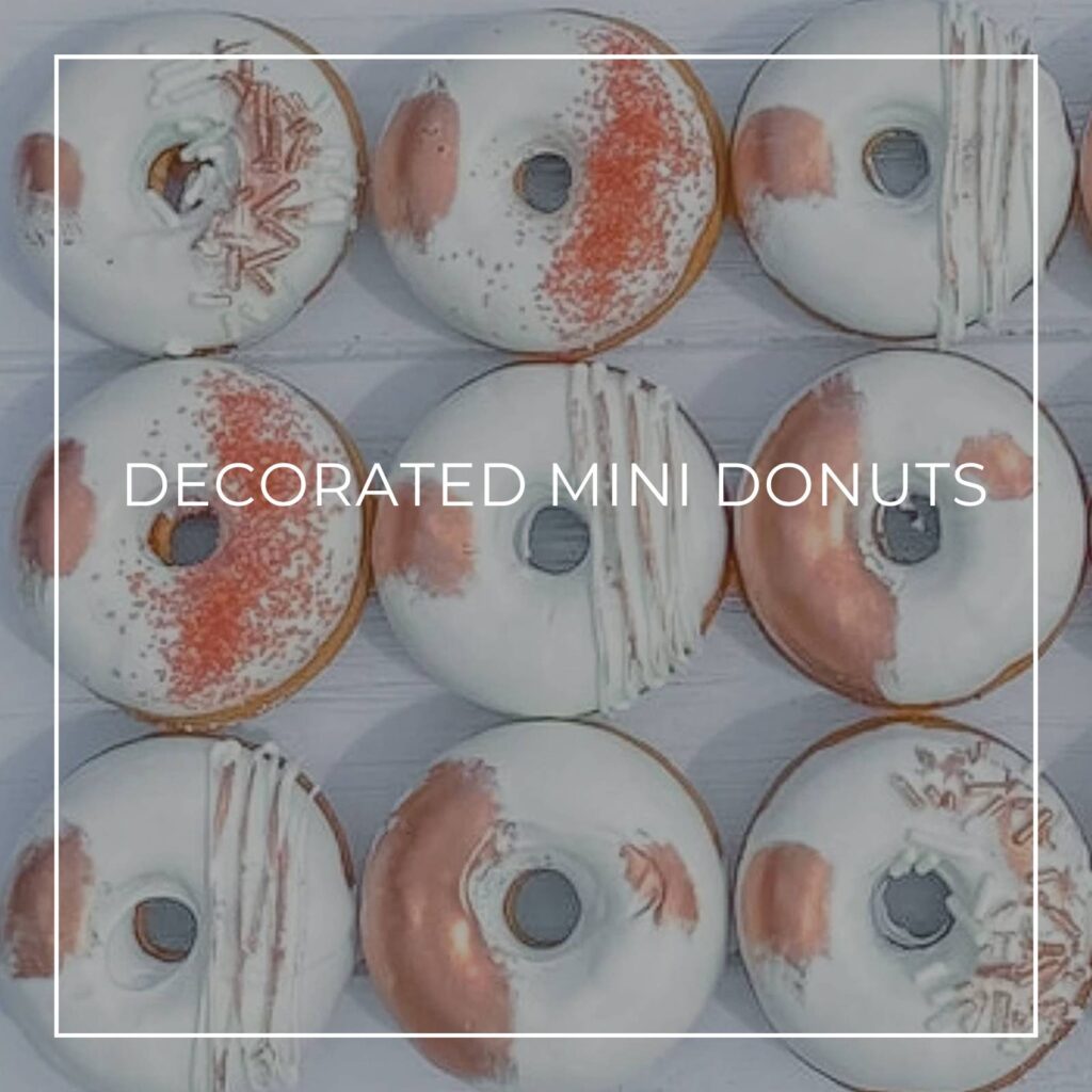 pink and white decorated mini donuts