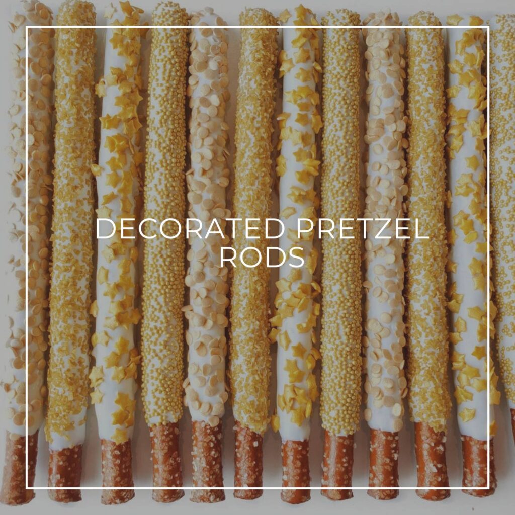 decorated pretzel rods dipped in white chocolate with yellow sprinkles