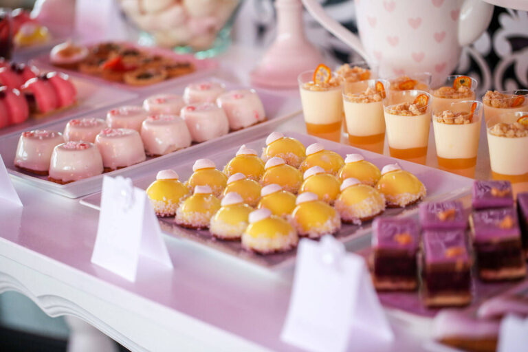 desserts laid out in groups on a party dessert table