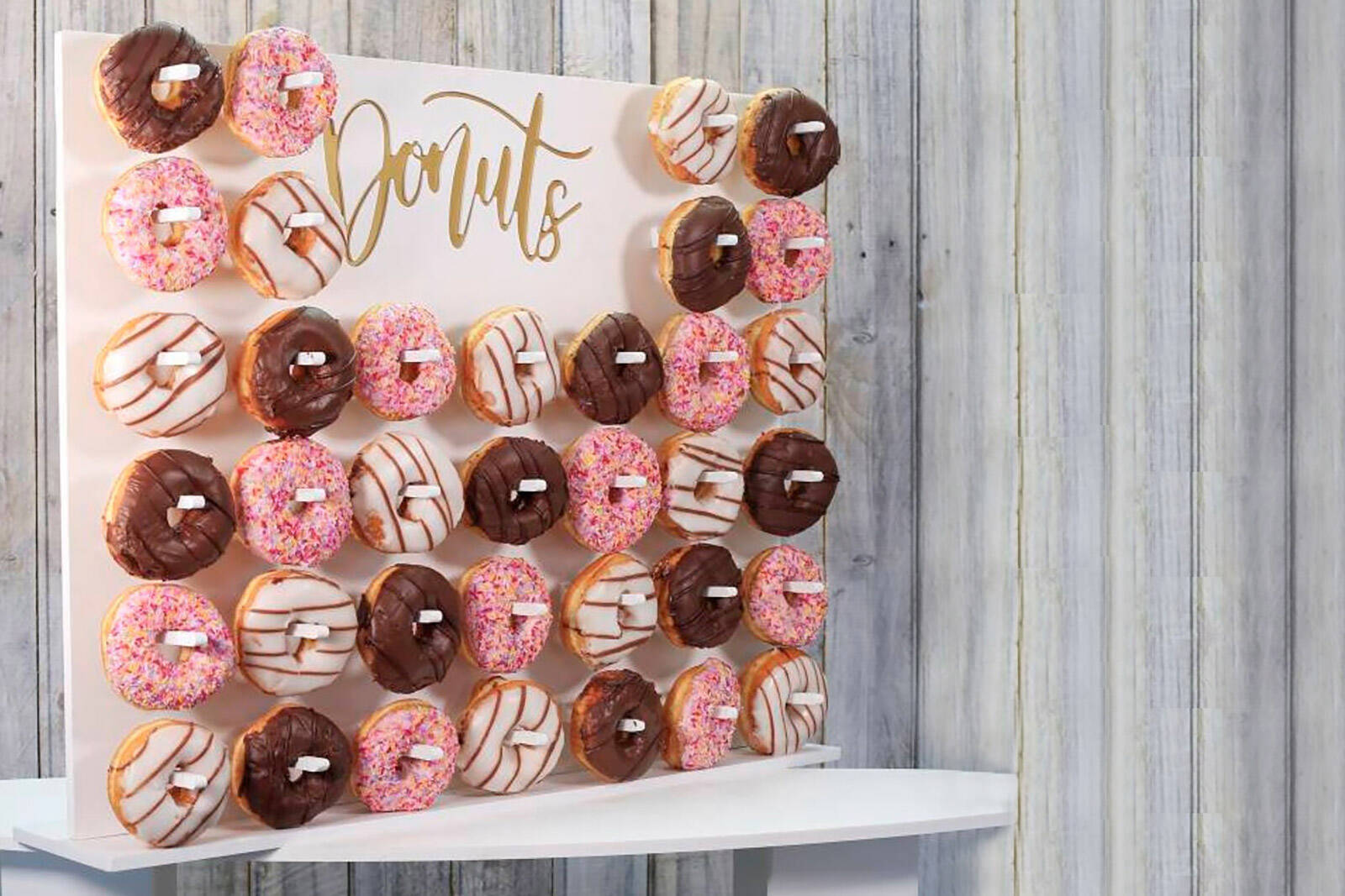 tall donut wall stand to add height to your dessert table layout