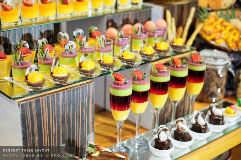 colorful desserts laid out in rows on a party dessert table