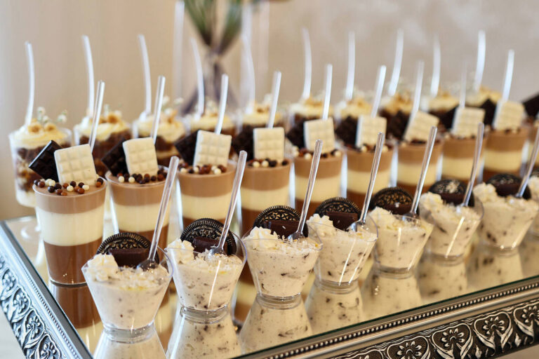 rows of desserts served in dessert cups and shooter glasses