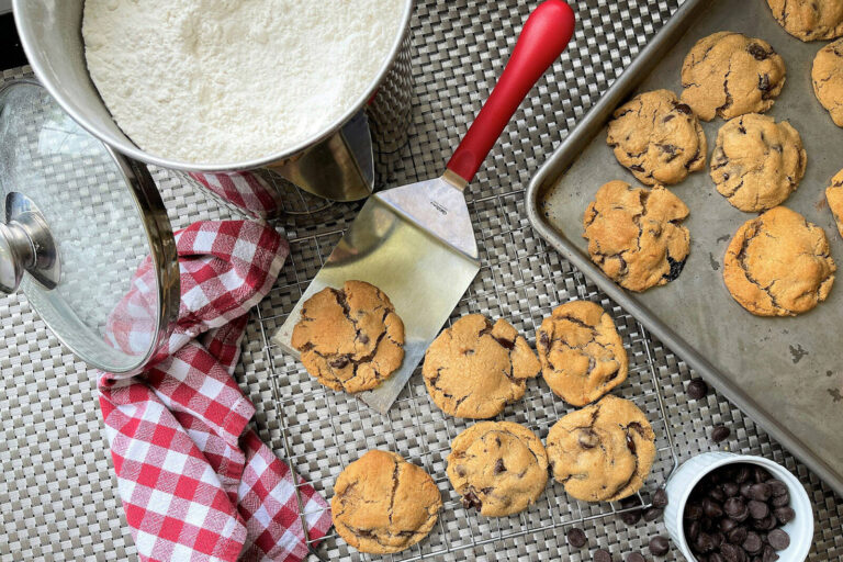 home made cookies on a cooling rack and baking tray next to a spatula