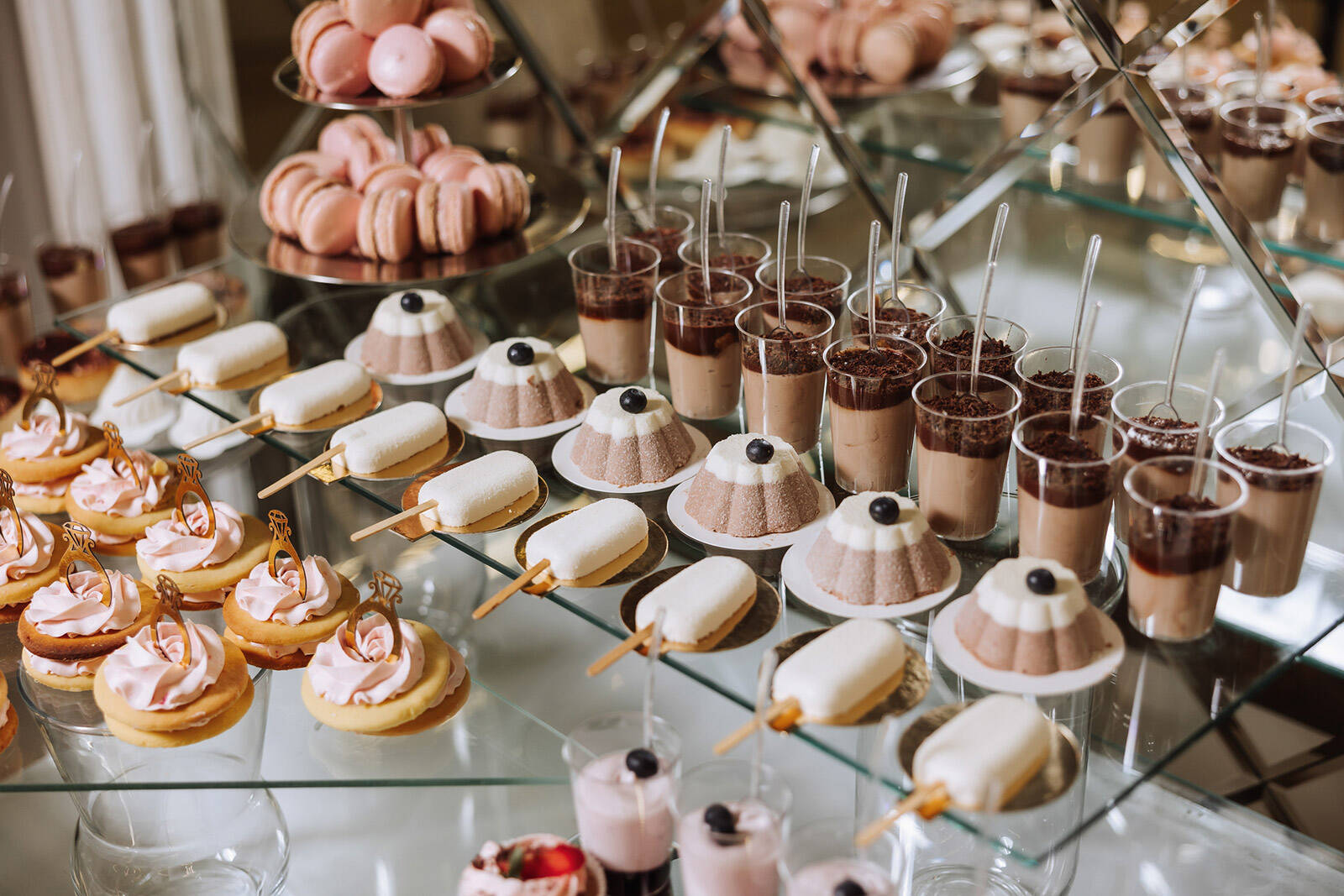 a variety of different mini desserts on a party dessert table