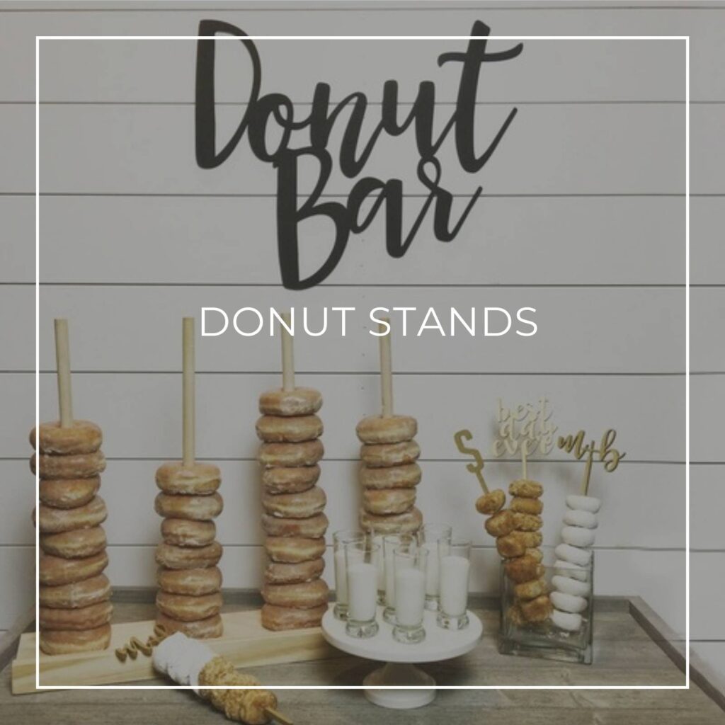 donuts stacked vertically on donut stands at a party donut bar