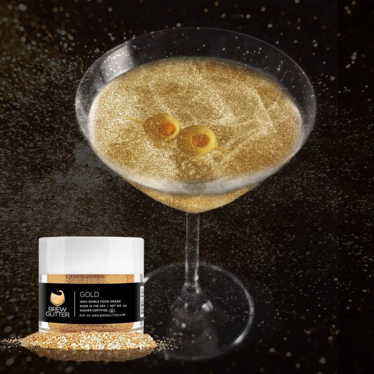 Gold edible glitter martini with two olives against a black background, styled next to the Brew Glitter jar