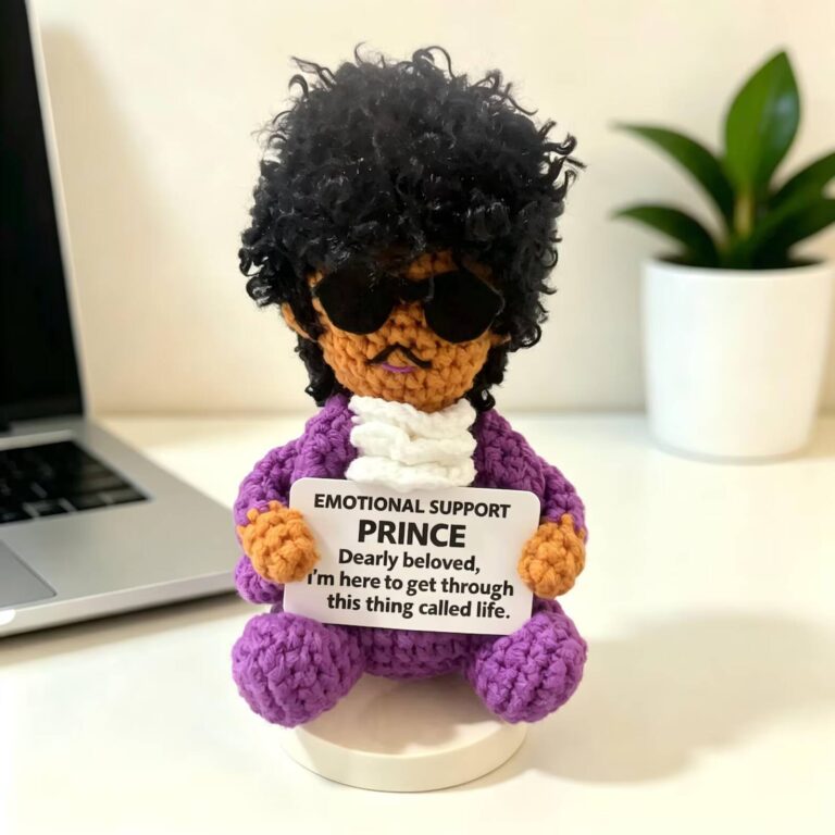 Emotional support Prince crochet doll in a purple outfit and sunglasses with a curly black wig