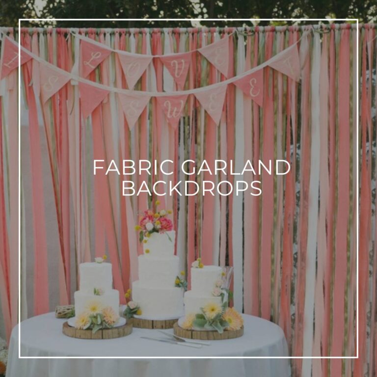 pink and white fabric strip garland party backdrop behind a cake table with 'love is sweet' banner