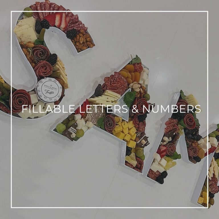 Fillable letters filled with charcuterie, cheese, and fruit for a party
