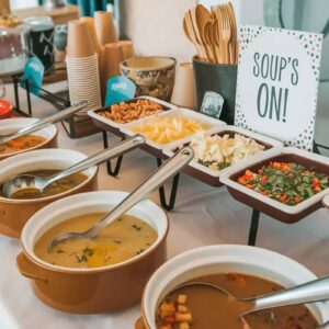Soup buffet station with slow cookers and toppings for a party