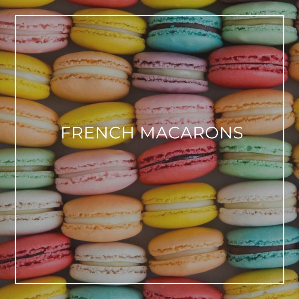 a tower of pastel colored French macarons on a party dessert table