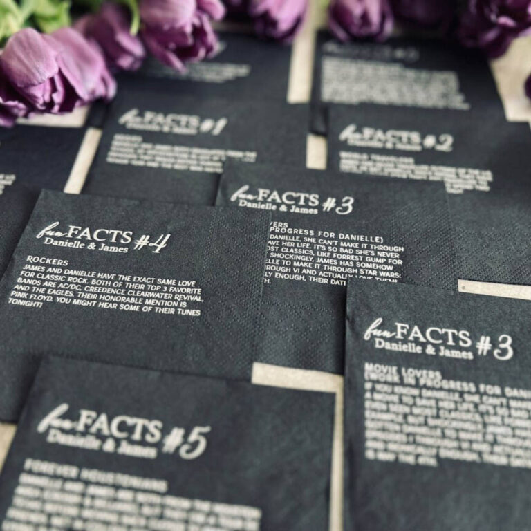 Black “fun FACTS Danielle and James” napkins numbered 1-5 among purple tulips, each with a titled fact