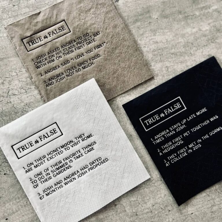 Grey, white, and black “True or False” napkins for Josh and Andrea, each with 3 numbered trivia statements