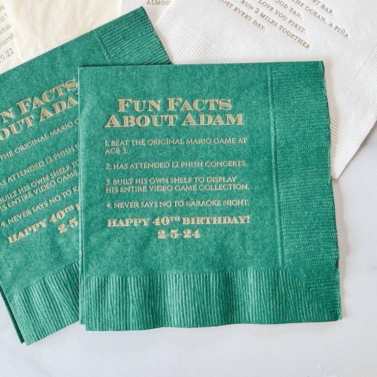 Orange “Maggie’s 50th Fun Fact” napkins No. 1 and No. 3, each printed with a story about Maggie