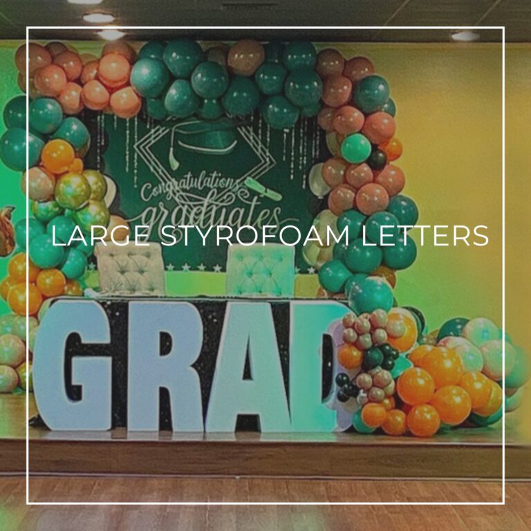 large white styrofoam letters spelling GRAD surrounded by balloons at a graduation party