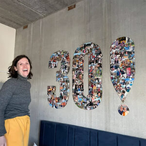large flat cardboard number 30 covered in a photo collage for a birthday party