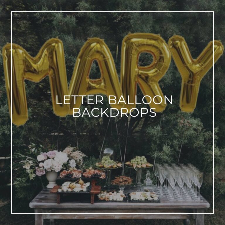 MARY spelled out with giant gold letter balloons as a backdrop to a party food table