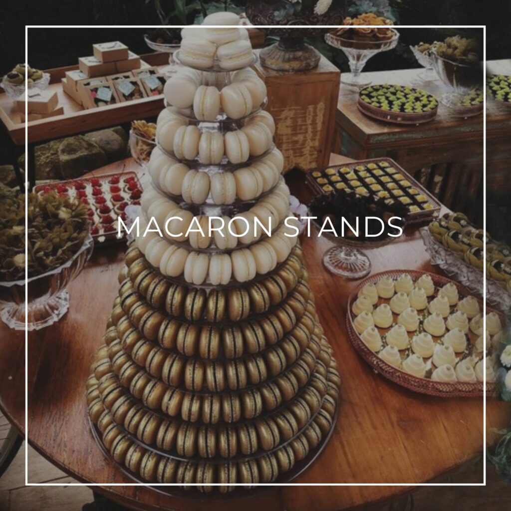 a macaron tower display stand on a party dessert table