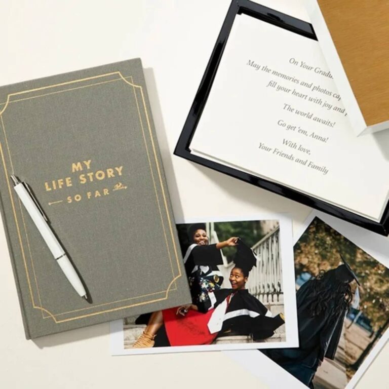 Journal shown beside a graduation card and photos as a graduation gift idea