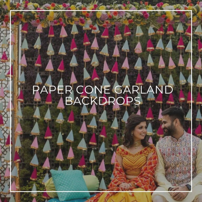 pastel pink, turquoise, and red paper cone garland backdrop for an indian wedding