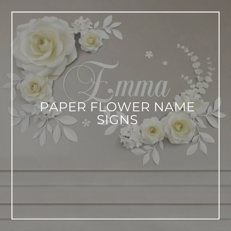 white paper flower and name sign spelling EMMA attached to a gray colored wall