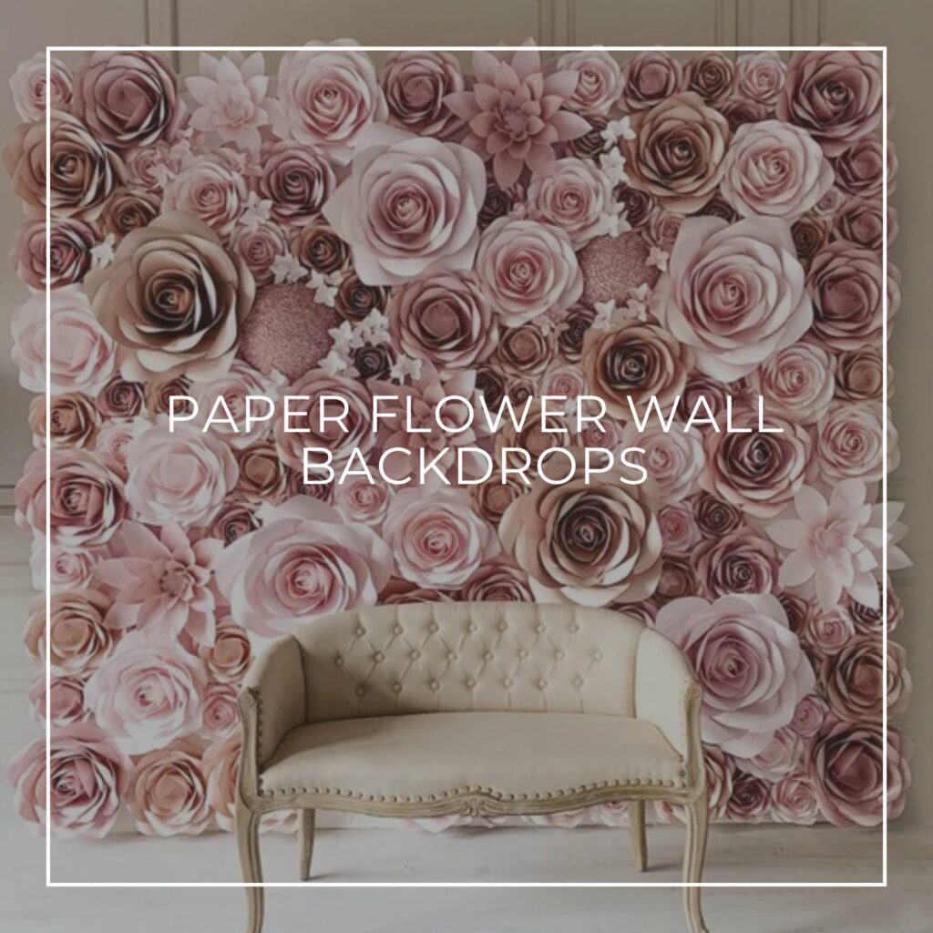 pink paper flower wall backdrop with a sofa in front