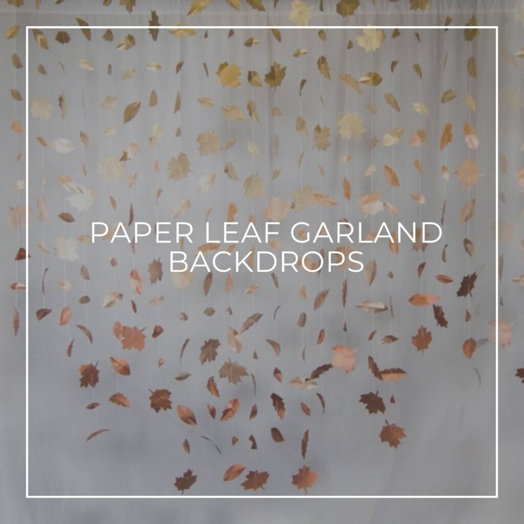 paper leaf garland backdrop hanging against white fabric