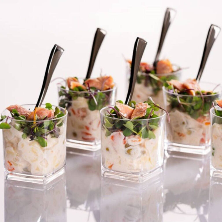 Shrimp salad appetizer cups with microgreens, served with mini forks