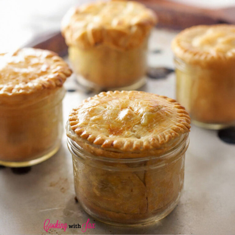 Mini chicken pot pies baked in mason jars with golden pastry lids