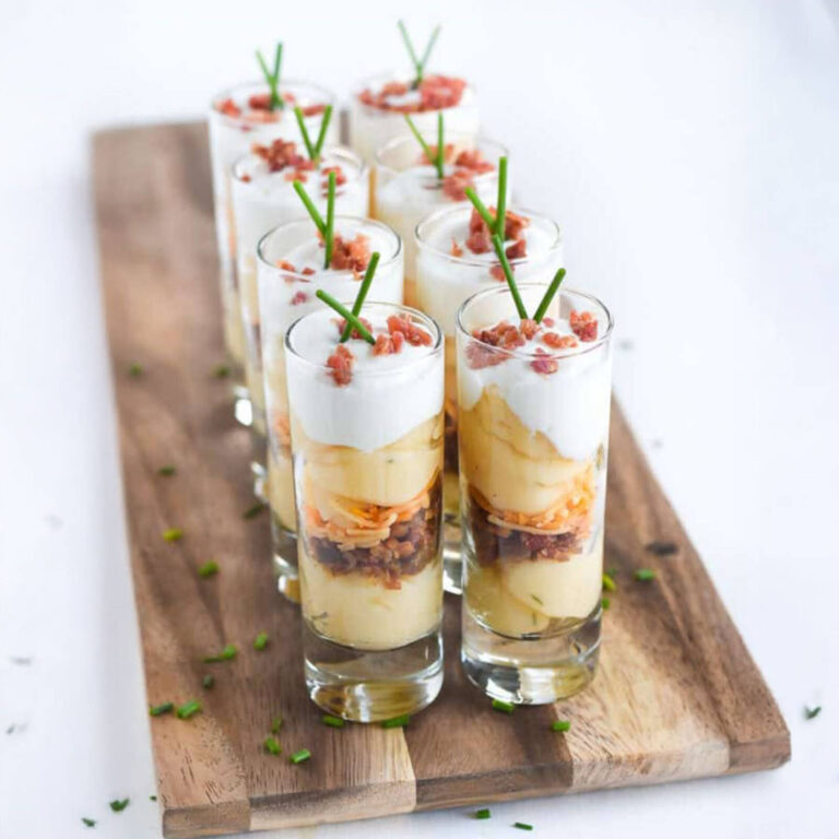 Loaded mashed potato shooters layered with bacon, cheese, and sour cream, topped with chives