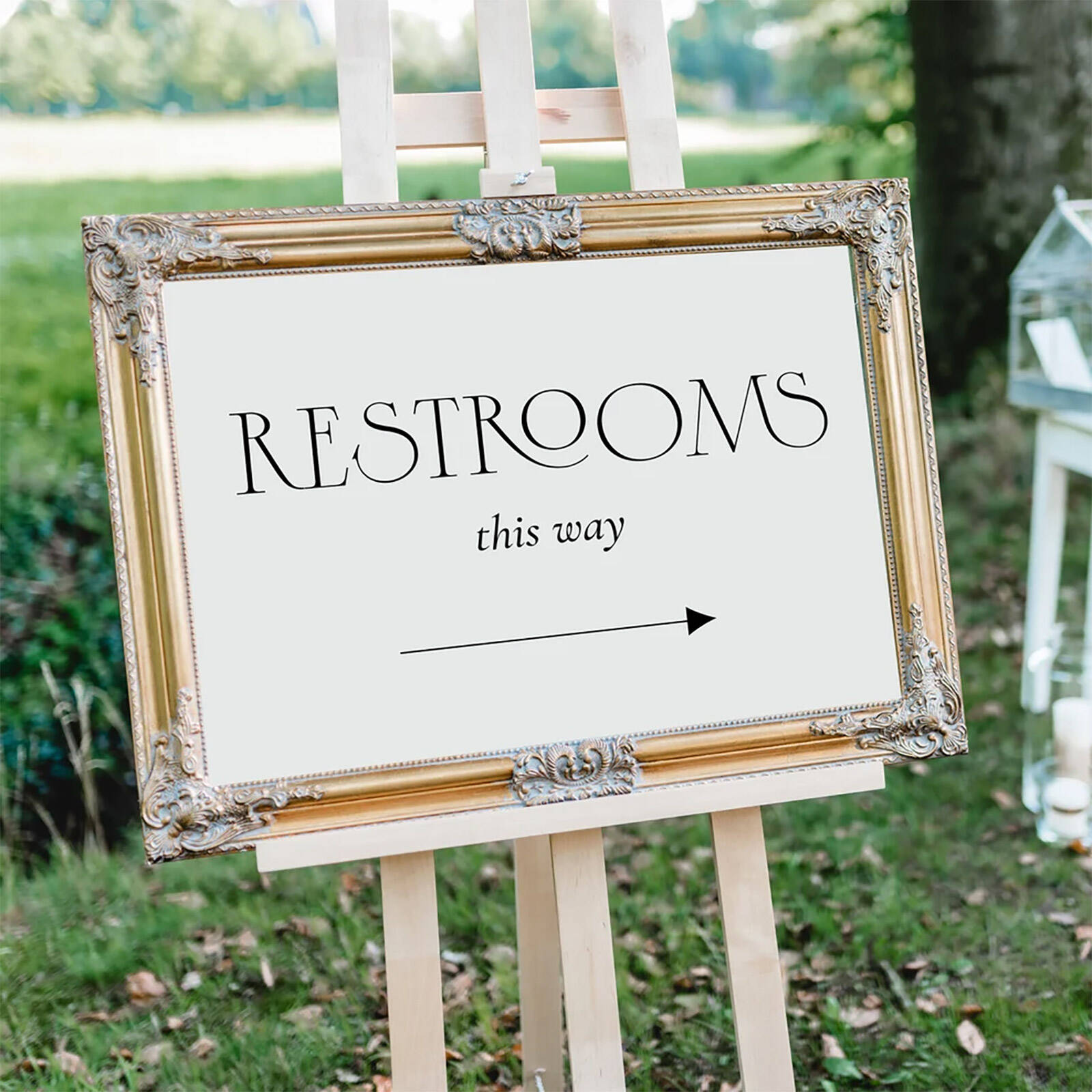 Restrooms this way framed party sign on an easel