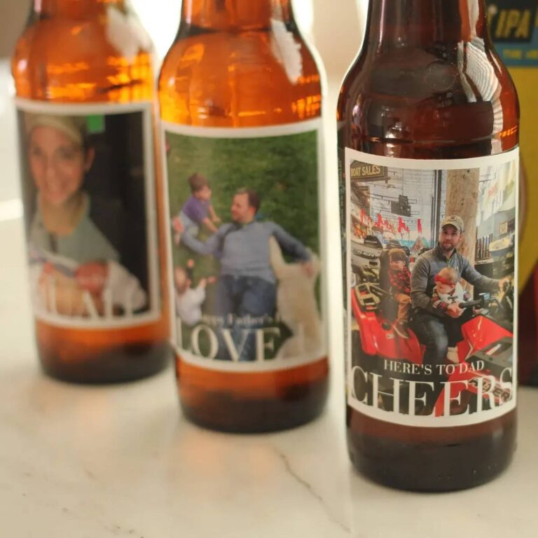 Three beer bottles with Father's Day photo labels reading "Love" and "Here's to Dad, Cheers," printed with family photos including a dad on an arcade ride with kids