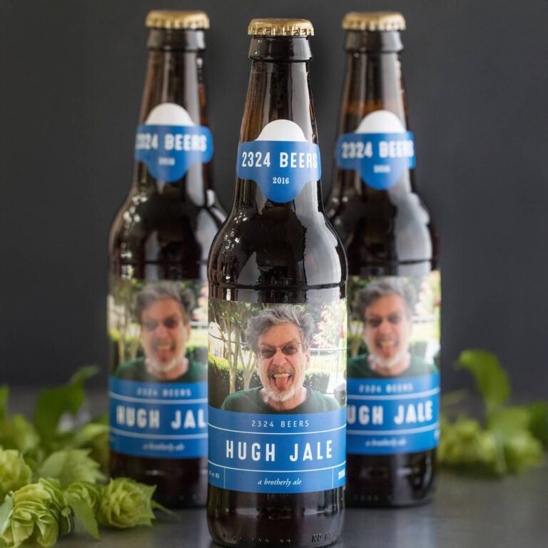 Three beer bottles with a punny "2324 Beers, Hugh Jale, a brotherly ale" label featuring a gray-haired man sticking his tongue out