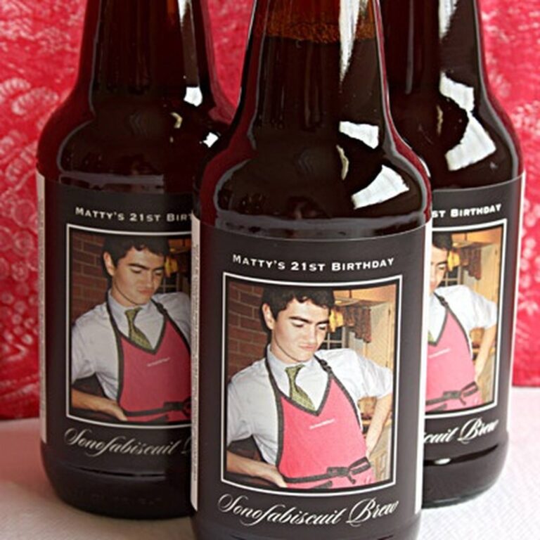 Three dark beer bottles with black "Matty's 21st Birthday, Sonofabiscuit Brew" labels featuring a photo of a young man in a pink apron