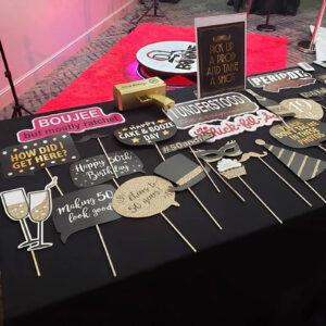 table of various 50th birthday party photo booth props