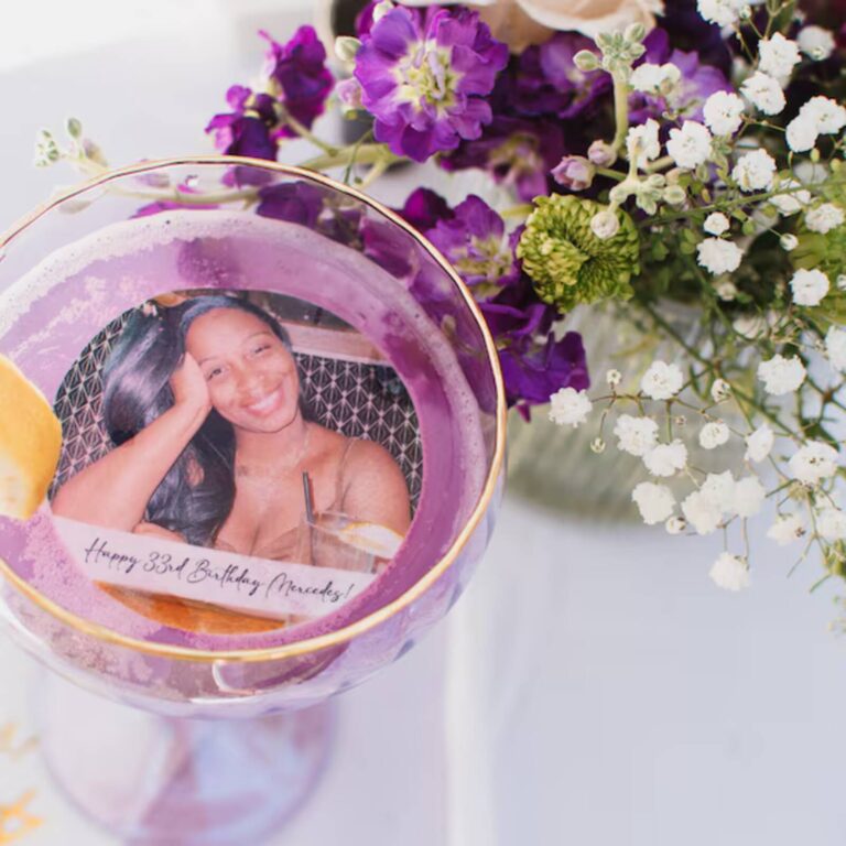 Edible photo drinks topper with birthday photo floating in a purple margarita