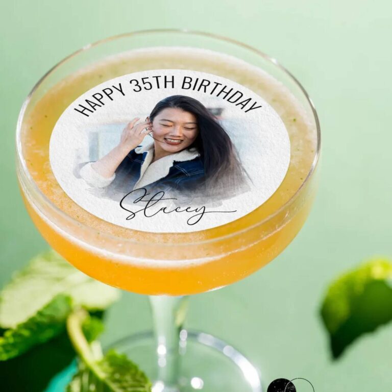 Edible photo drinks topper with birthday photo in an orange cocktail