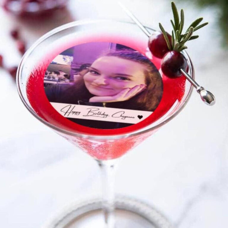 Edible photo drinks topper with birthday photo in a red cocktail with cranberry garnish