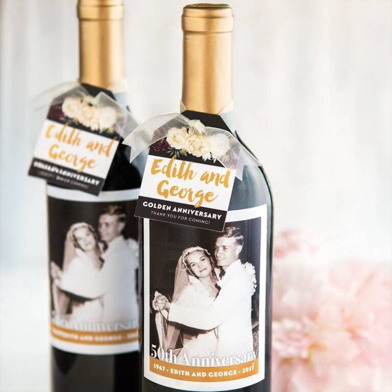 Two wine bottles with gold-ribboned hangtags reading “Edith and George, Golden Anniversary” and matching labels of a black-and-white wedding photo, “50th Anniversary, 1967-2017”