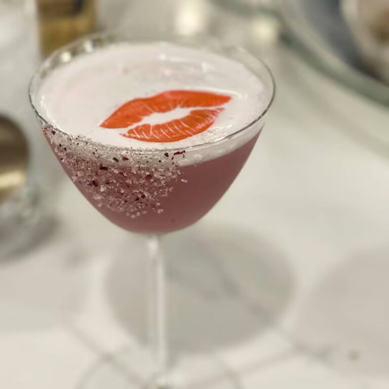 Edible red lips topper on a cocktail with a sugared rim