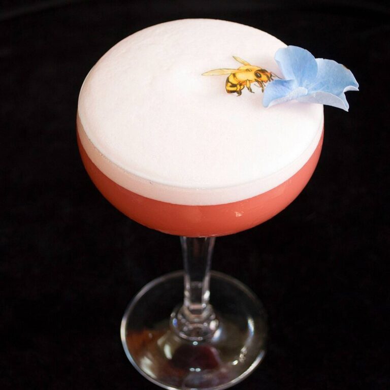 Edible bee and flower topper on a foam-topped cocktail
