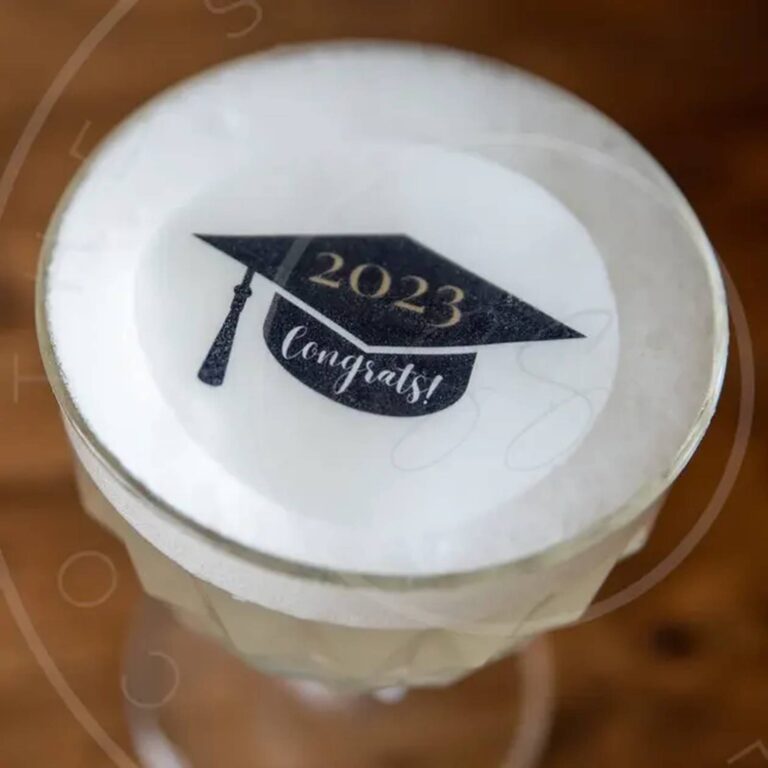 Edible graduation cap topper reading 2023 Congrats on a drink