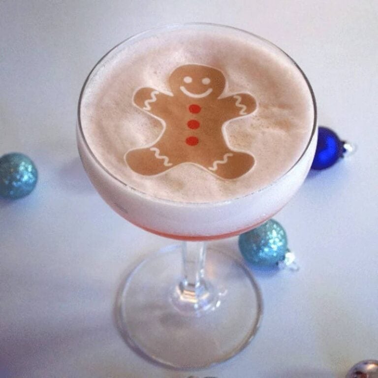Edible gingerbread man topper on a foam-topped holiday drink
